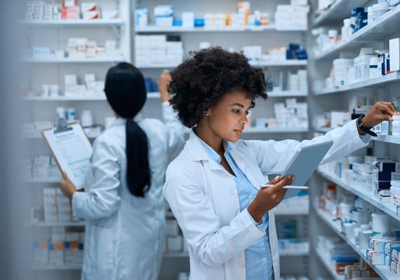 Pharmacist looking at medications in a pharmacy